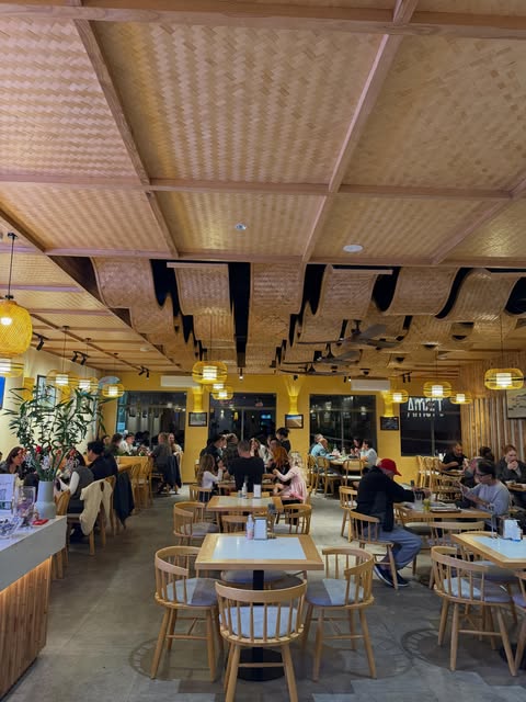 Guests dining beneath woven lanterns inside Special Dish